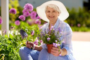 The Gardens of Castle Hills | Senior with flowerpot