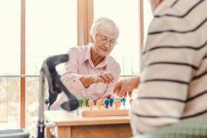 The Gardens at Castle Hills | Senior woman playing memory care games