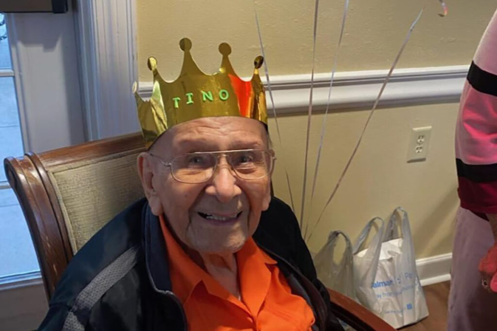 The Gardens at Castle Hills | Tino Rodriguez, 102 years old, wearing party hat and smiling