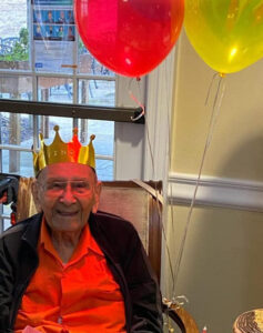 The Gardens at Castle Hills | Tino Rodriguez, 102 years old, wearing party hat and smiling