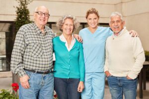 The Gardens of Castle Hills | Seniors smiling with family and caregiver