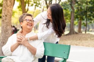 The Gardens of Castle Hills | Boerne dementia care - senior woman with caregiver sitting outside